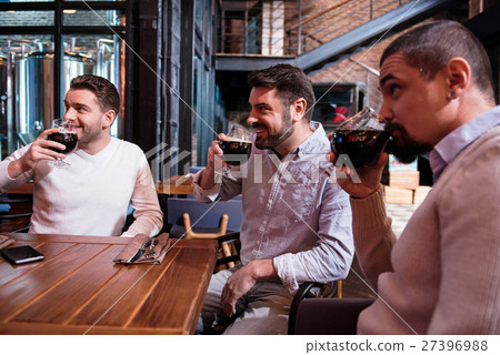 Positive handsome men tasting beer Positive handsome men tasting beer 27396988