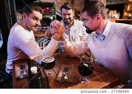 Good looking male friends armwrestling Good looking male friends armwrestling 27396989