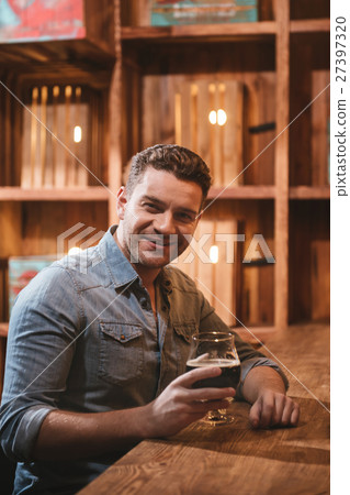 Handsome delighted man enjoying his beer Handsome delighted man enjoying his beer 27397320