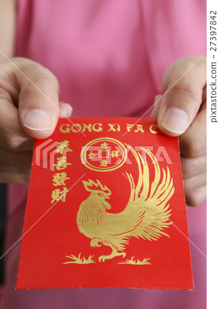 Holding chinese new year angpow red packet Holding chinese new year angpow red packet 27397842