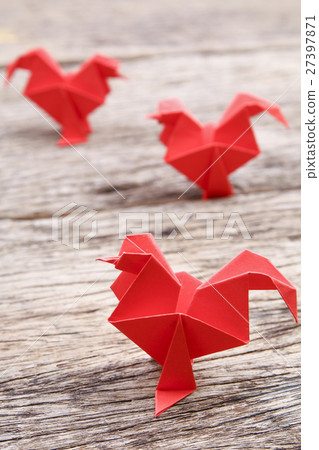 Red origami chicken on wooden surface Red origami chicken on wooden surface 27397871