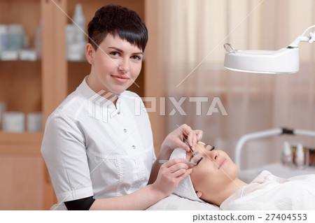 Eyelash Extension Procedure. Woman Eye with Long Eyelash Extension Procedure. Woman Eye with Long 27404553