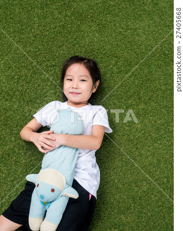 little asian kid girl lay down on the lawn  27405668