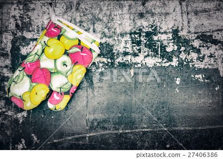 Kitchen glove hang on old wooden background. 27406386