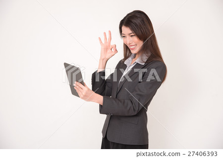 Businesswoman holding tablet and OK sign gesture. Businesswoman holding tablet and OK sign gesture. 27406393