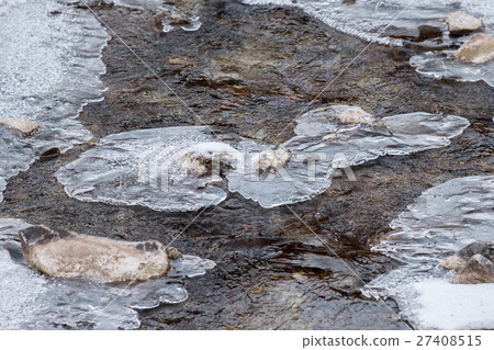 Frozen creek small waterfall in winter time 27408515