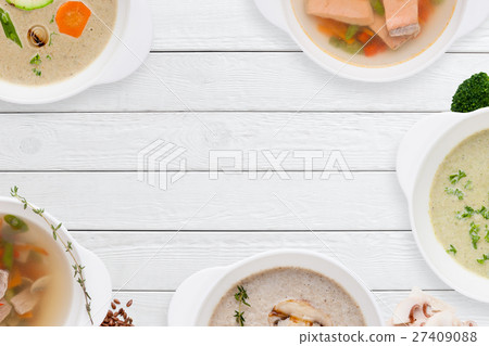 Frame of different soups on white wooden table Frame of different soups on white wooden table 27409088