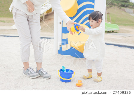 Parent and child mother and daughter playing sand 27409326