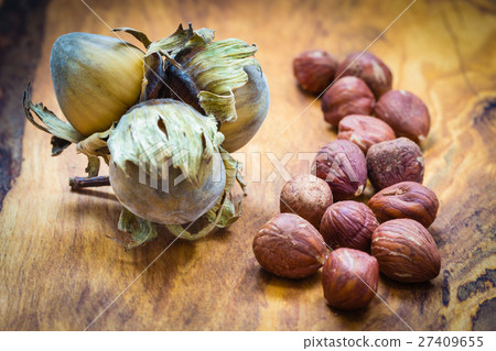 Hazelnuts cluster filbert nuts in the hard shell. Hazelnuts cluster filbert nuts in the hard shell. 27409655