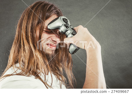 Unhappy male playing games Unhappy male playing games 27409667