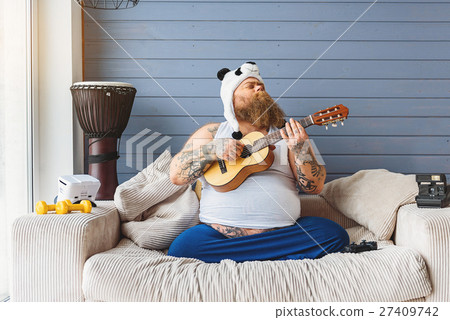 Fat man enjoying own music Fat man enjoying own music 27409742