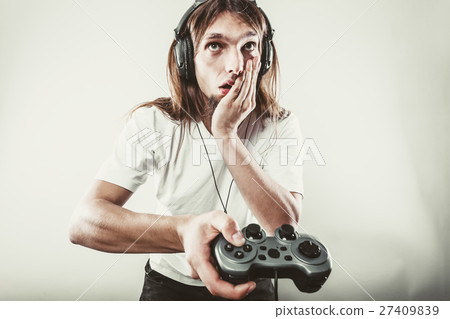 Unhappy male playing games 27409839