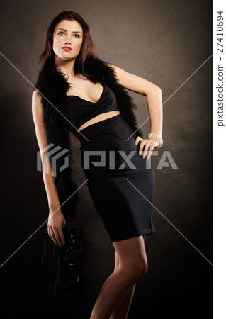 woman evening dress handbag in hand on black 27410694