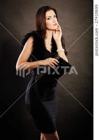 woman evening dress handbag in hand on black 27410699