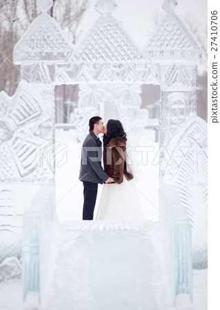Winter wedding couple kissing in the middle of the 27410706