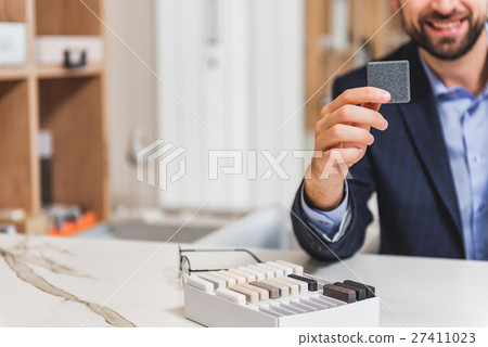 Successful businessman selling objects for 27411023