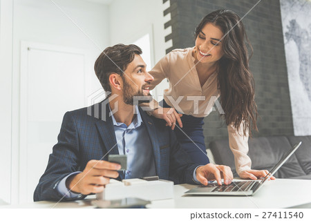Joyful shop assistant selling design objects Joyful shop assistant selling design objects 27411540