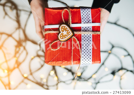 girl holding a Christmas gift in hand girl holding a Christmas gift in hand 27413099