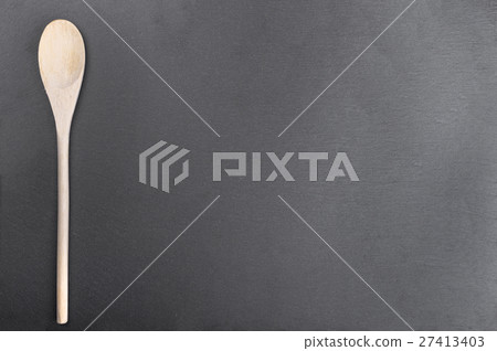 wooden spoon on slate blackboard 27413403