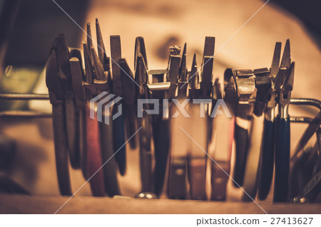 Different goldsmiths tools on the jewellery Different goldsmiths tools on the jewellery 27413627