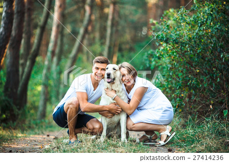 Happy couple of future parents with pet 27414236
