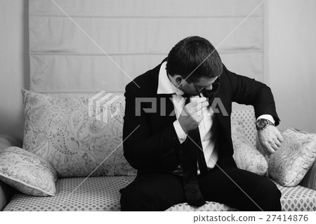 businessman looking at his wristwatch businessman looking at his wristwatch 27414876