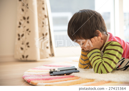 A boy who sleeps and watches a smartphone 27415364