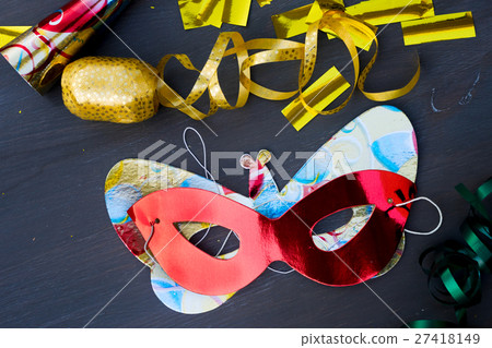 Masquerade decorations on dark wooden background Masquerade decorations on dark wooden background 27418149
