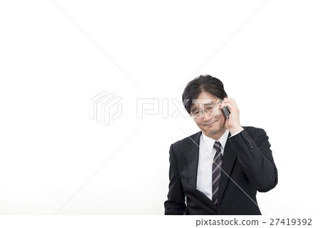 A middle-aged businessman talking with a smartphone with a troubled look 27419392