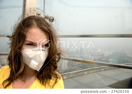 Woman in medical mask against the air pollution Woman in medical mask against the air pollution 27420159