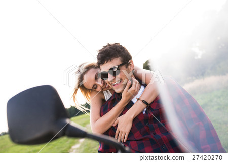 Couple in love enjoying a motorbike ride in 27420270