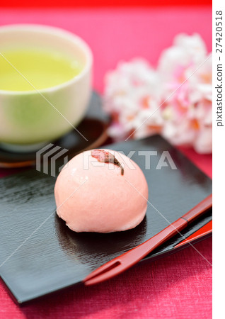 Spring Japanese confection, Cherry Manju / Cherry Bun and image of green tea. Attention) Cherry blossoms in the background are artificial flowers. Spring Japanese confection, Cherry Manju / Cherry Bun and image of green tea. Attention) Cherry blossoms in the background are artificial flowers. 27420518