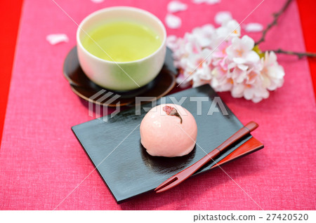 Spring Japanese confection, Cherry Manju / Cherry Bun and image of green tea. Attention) Cherry blossoms in the background are artificial flowers. Spring Japanese confection, Cherry Manju / Cherry Bun and image of green tea. Attention) Cherry blossoms in the background are artificial flowers. 27420520