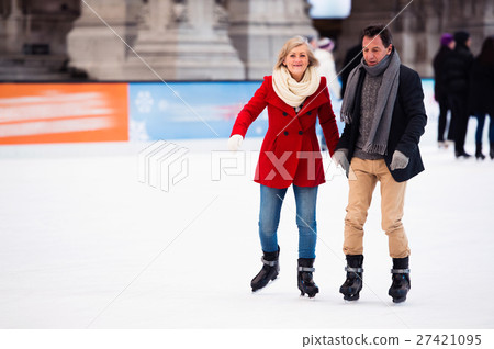 Beautiful senior couple ice skating in city centre 27421095