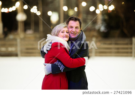 Beautiful senior couple ice skating in city centre 27421096