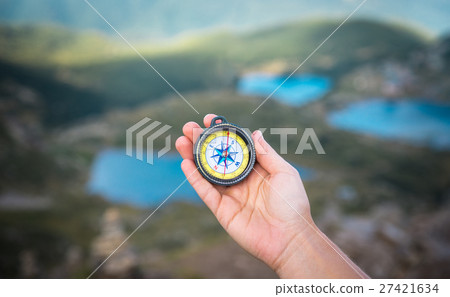 compass and hand in mountains compass and hand in mountains 27421634
