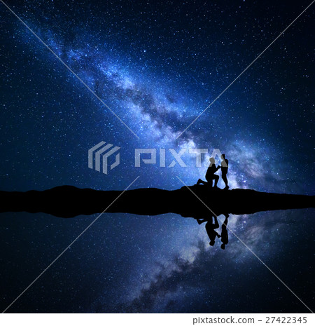 Milky Way. Night sky with silhouettes of a couple Milky Way. Night sky with silhouettes of a couple 27422345