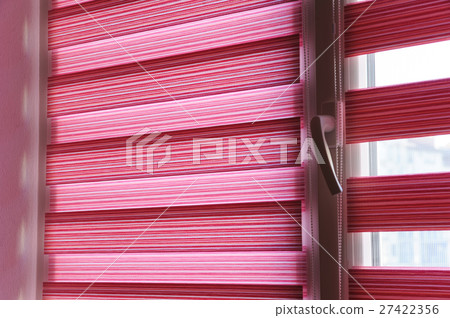 Fabric roller blinds on the window. Fabric roller blinds on the window. 27422356