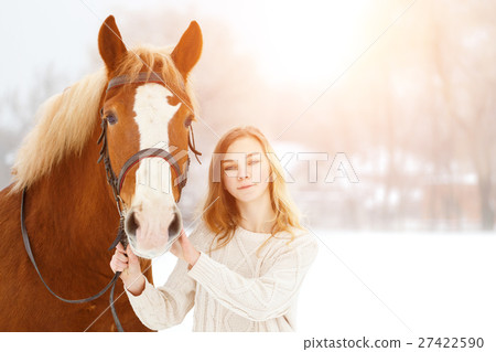 Young teenage happy girl with horse in winter park Young teenage happy girl with horse in winter park 27422590