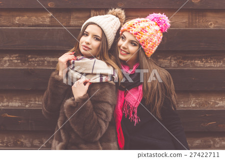 Two pretty girl are wearing warm winter clothes Two pretty girl are wearing warm winter clothes 27422711