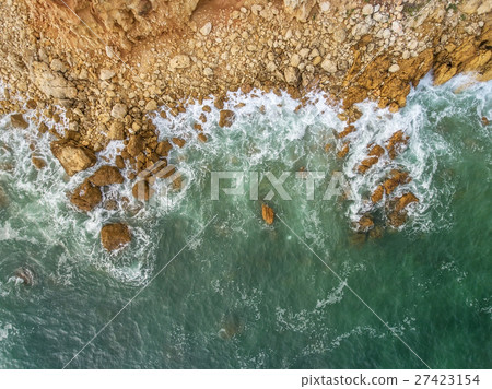 Aerial. Waves beat against the shore, the view 27423154