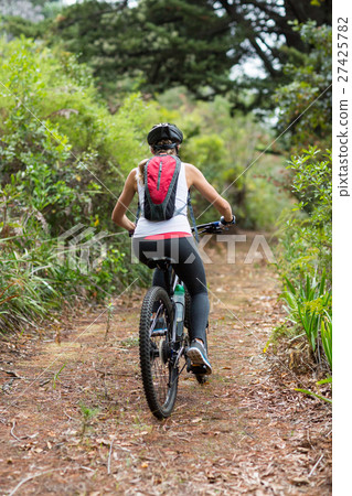 Woman cycling in countryside 27425782