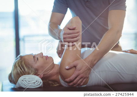Woman receiving shoulder therapy from physiotherapist Woman receiving shoulder therapy from physiotherapist 27425944
