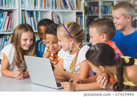 School kids using laptop in library School kids using laptop in library 27425949
