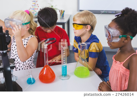Kids doing a chemical experiment in laboratory Kids doing a chemical experiment in laboratory 27426014