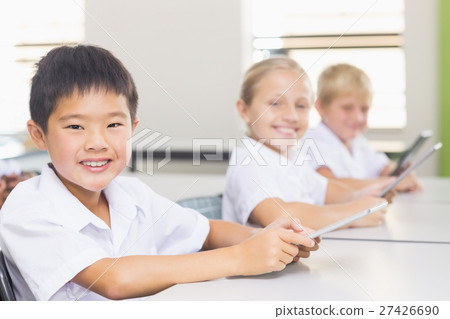 Kids using digital tablet in classroom Kids using digital tablet in classroom 27426690
