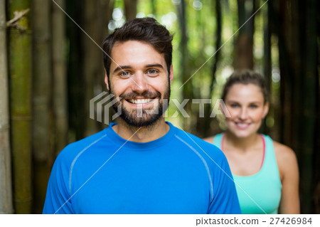 Couple standing in forest Couple standing in forest 27426984