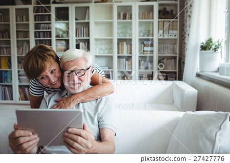 Senior couple using digital tablet 27427776