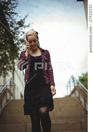 Woman talking on mobile phone Woman talking on mobile phone 27428152