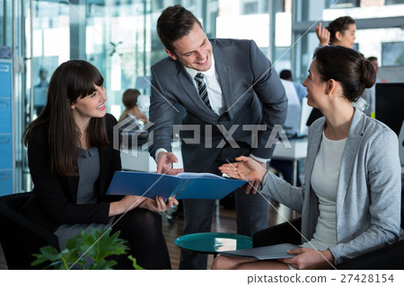 Businesspeople discussing over document Businesspeople discussing over document 27428154